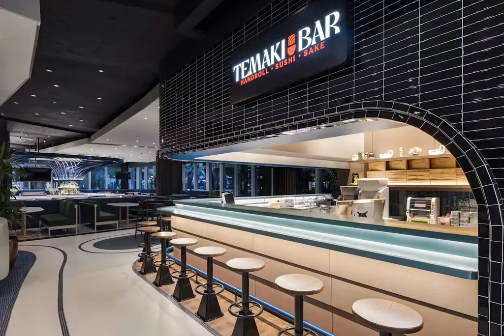 Modern 'TEMAKI BAR' with illuminated sign for handroll, sushi, and sake.