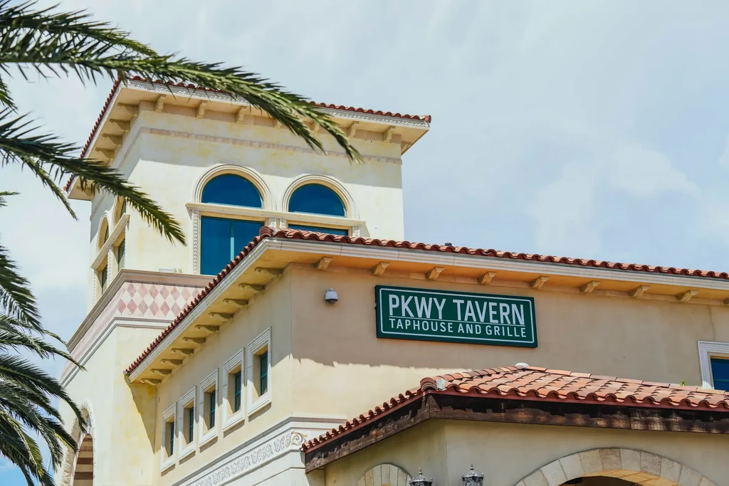 PKWY TAVERN TAPHOUSE AND GRILLE on a stucco Mediterranean building.