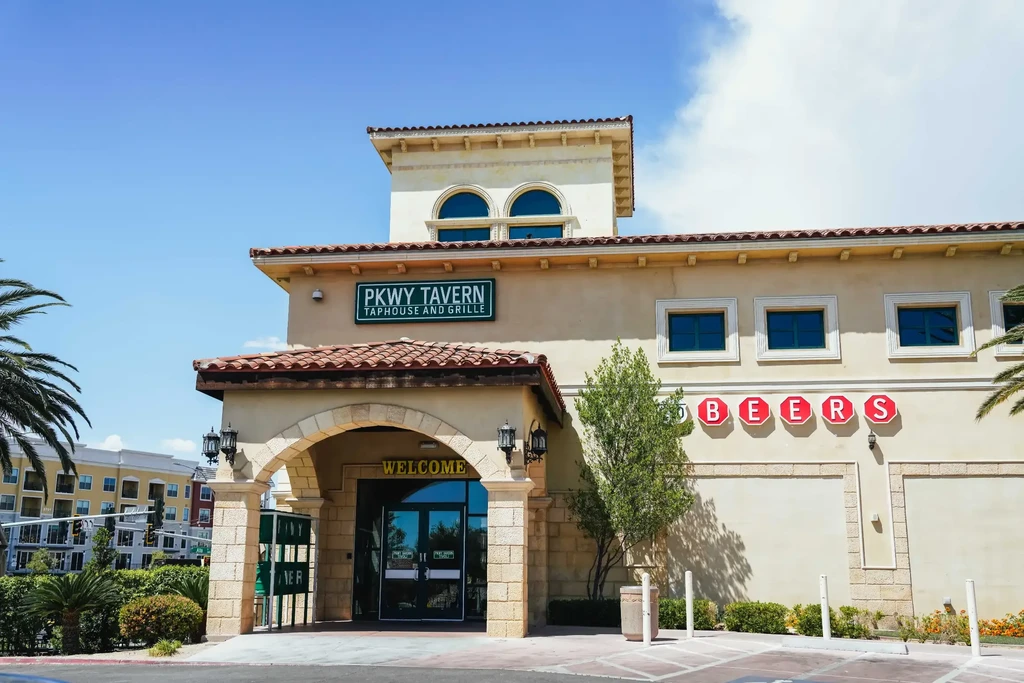 PKWY TAVERN TAPHOUSE: Mediterranean-style stucco building, red tile roof.
