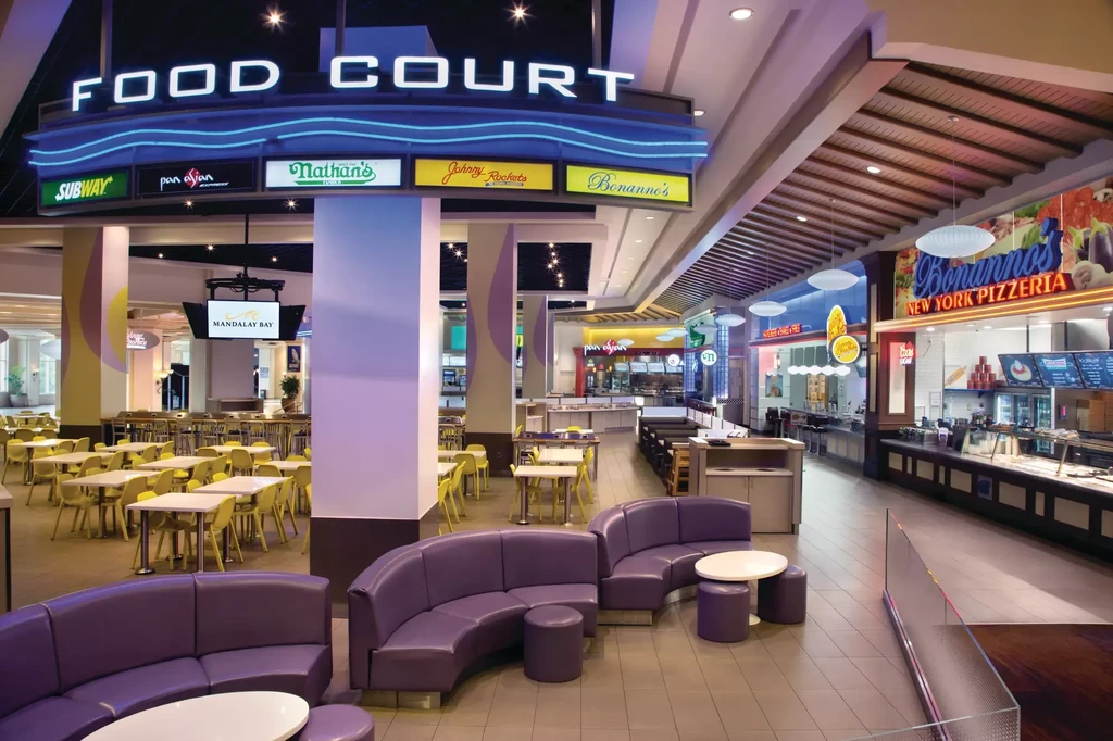 Spacious, modern food court featuring diverse fast-casual restaurants and seating areas.