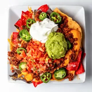 Nachos generously topped with cheese, meat, pico, guacamole, sour cream, jalapeños.