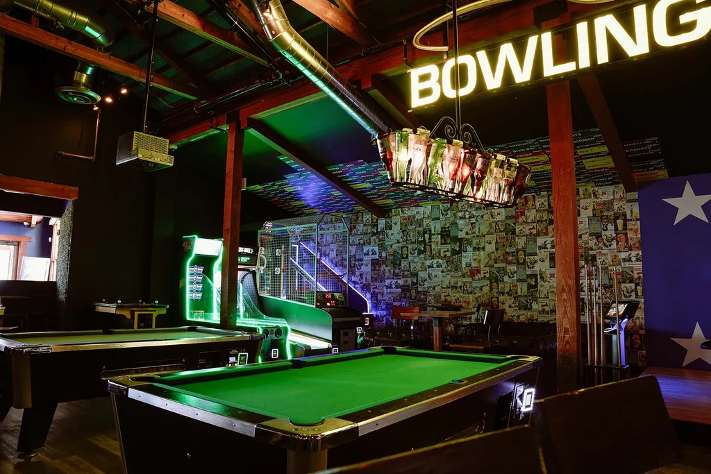 Vibrant bowling alley interior with pool tables, arcade games, and unique decor.