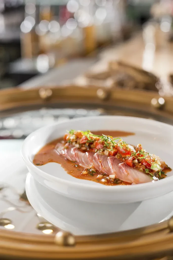 Elegant fish crudo with tomato-herb salsa and rich sauce.