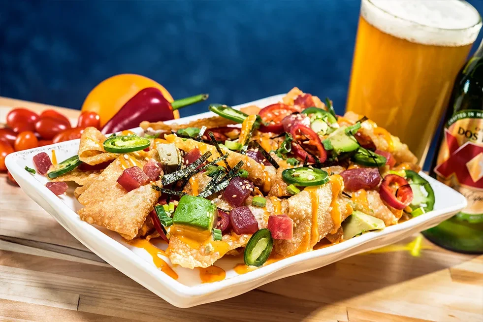 Ahi poke wonton chips with tuna, avocado, jalapeños, and beer.