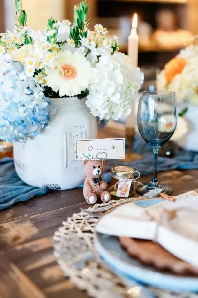 Elaborate table setting with floral centerpiece, lit candle, and "Chiara" place card.