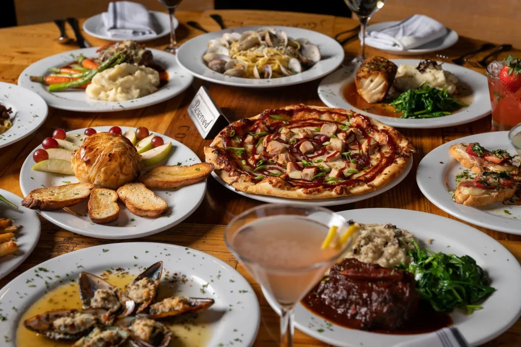 Festive, upscale dining table laden with diverse food and drinks.
