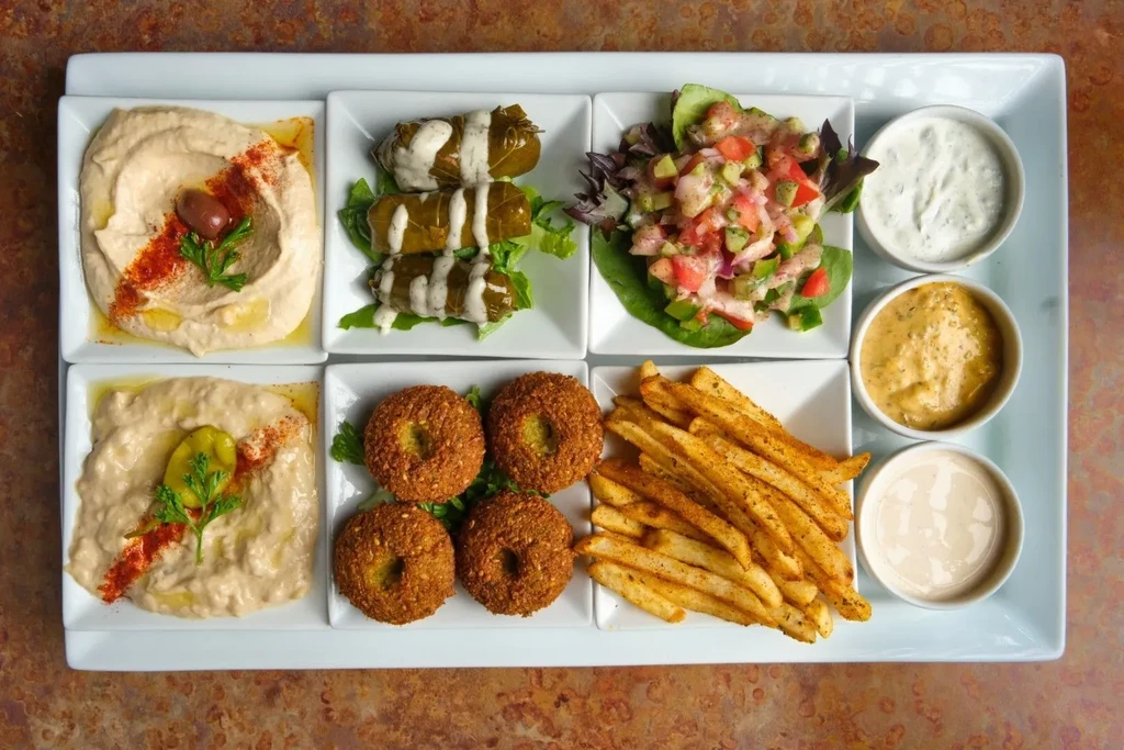 Overhead view of Middle Eastern platter with hummus, falafel, and salad.