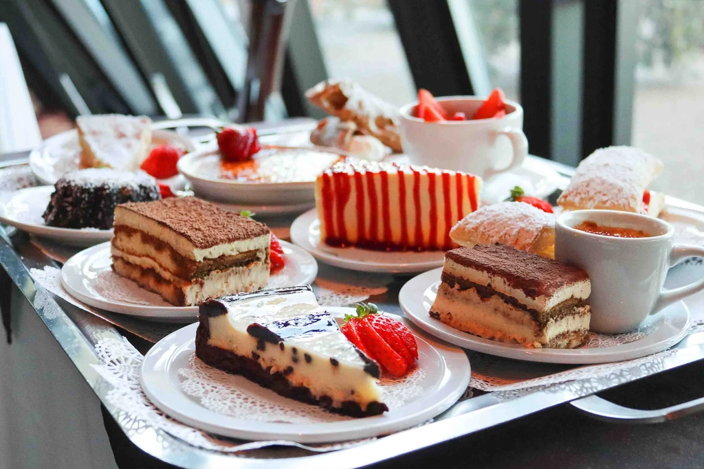 Assorted pastries, cheesecakes, and a lava cake on a silver tray.