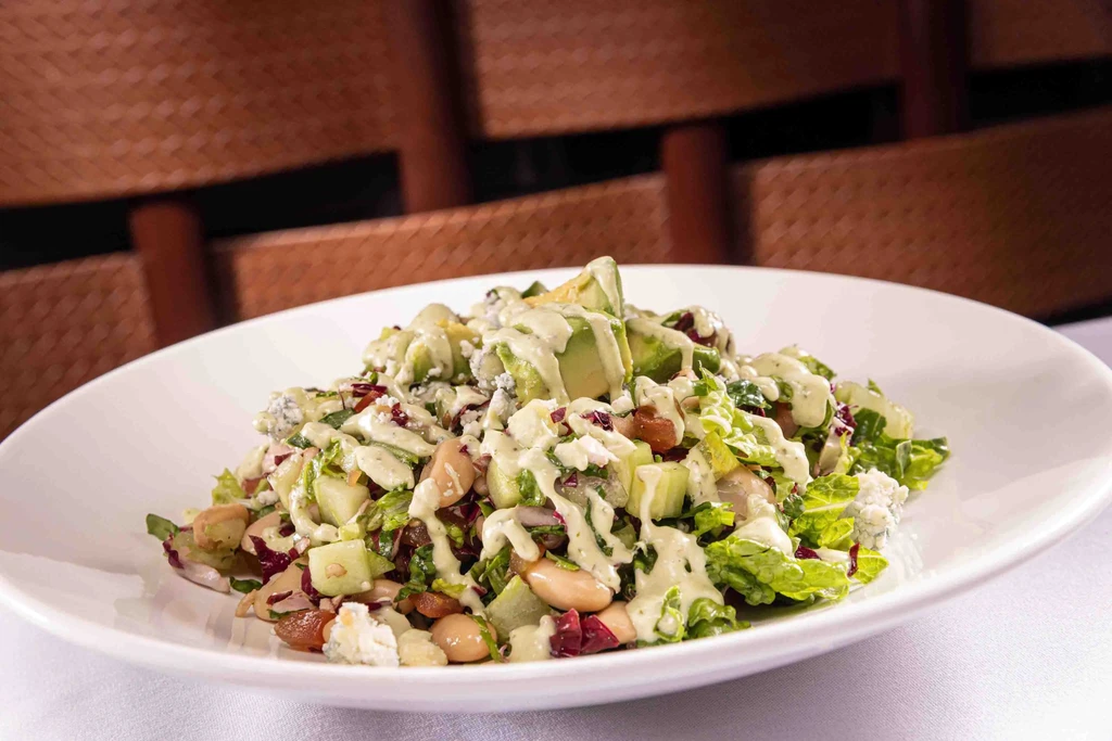 Avocado salad with greens, white beans, blue cheese, and creamy dressing.