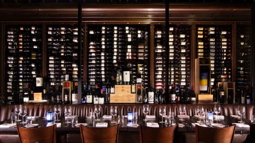 Sophisticated restaurant dining area featuring a prominent wine wall.