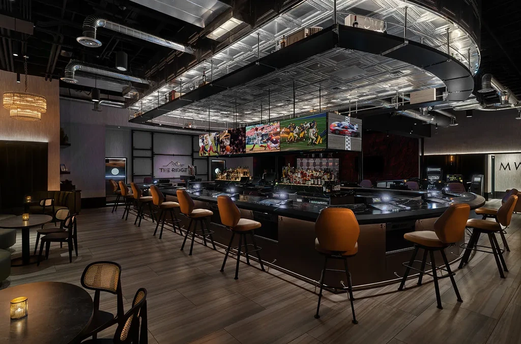 Empty upscale sports bar "THE RIDGE" with U-shaped bar and lounge.