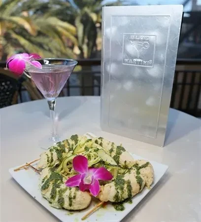 Orchid-garnished chicken skewers, pink martini, and Blue Martini menu.