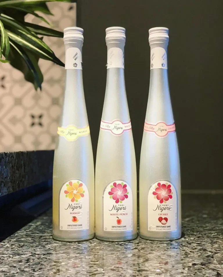 Three Yuki Nigori sake bottles: Mango, White Peach, Lychee.