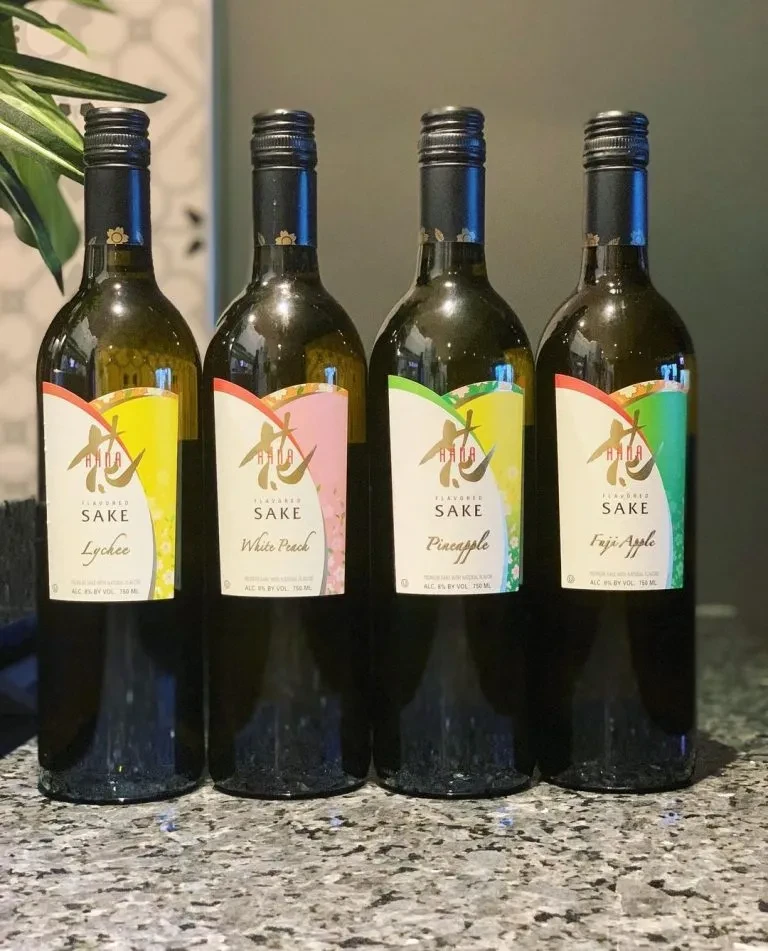 Four Hana Flavored Sake bottles: Lychee, Peach, Pineapple, Apple.