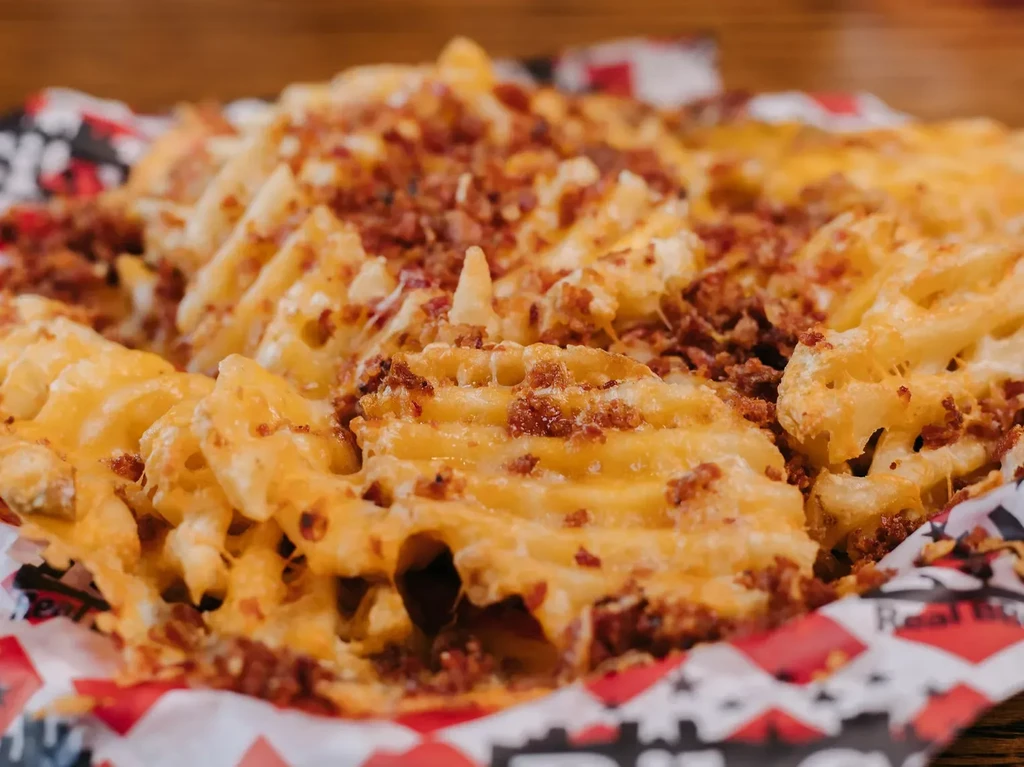 Waffle fries loaded with melted cheese and crispy bacon.