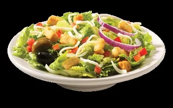 Fresh garden salad with lettuce, bell peppers, onion, olives, and croutons.