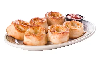 Six golden baked rolls with red dipping sauce on a plate.