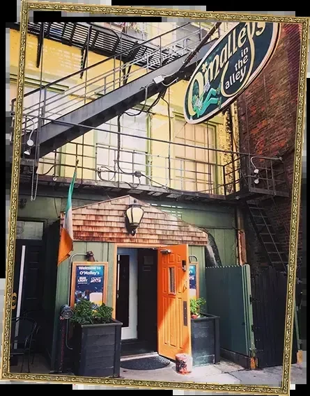 O'Malley's in the Alley: colorful urban Irish pub entrance, no people.