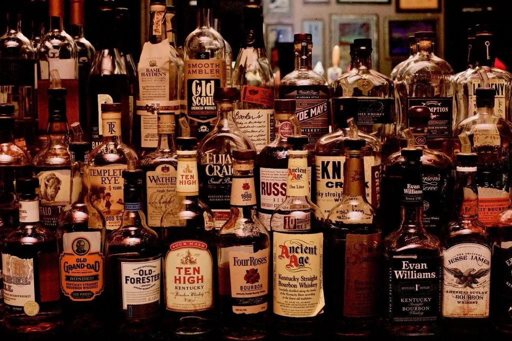 Closely arranged whiskey and bourbon bottles with visible brand labels.