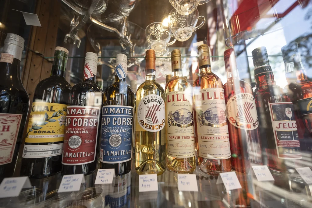Retail display of Bonal, Cocchi Americano, and Lillet bottles.