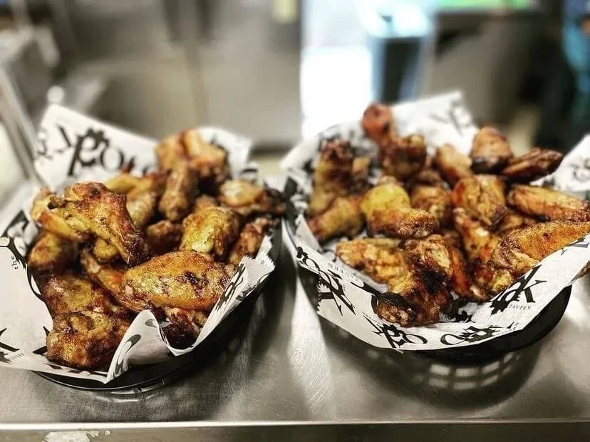 Golden-brown, crispy chicken wings in two baskets from The Rock Tavern.