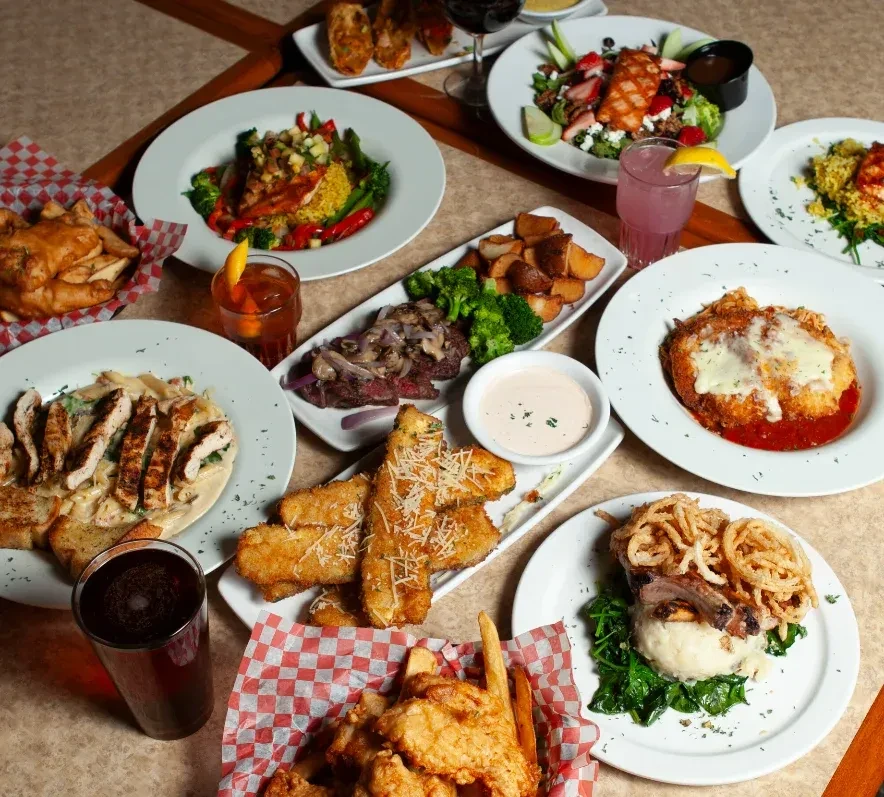 High-angle view of various dishes and drinks on a restaurant table.