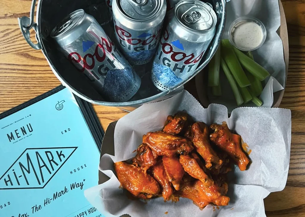 Coors Light cans, buffalo wings, celery, dip, and Hi-Mark House menu.