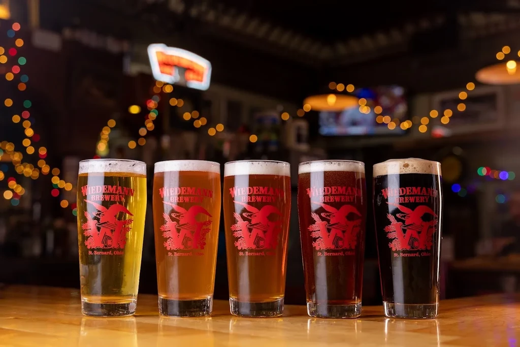 Five glasses of Wiedemann beer, from light lager to dark stout.