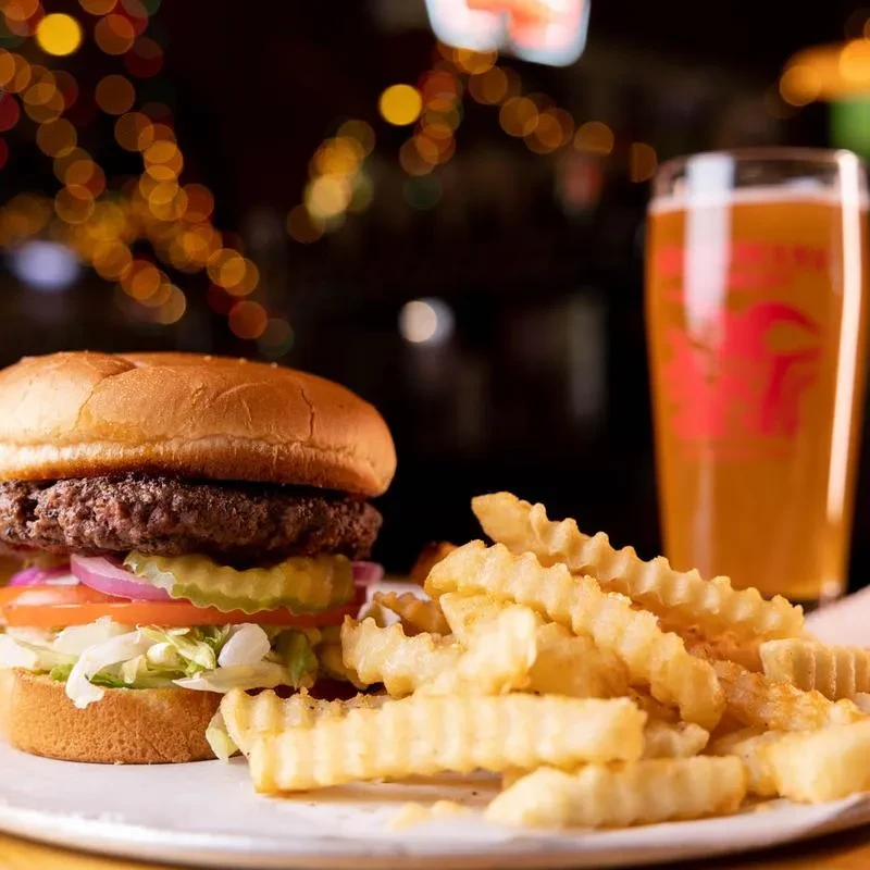 Cheeseburger, crinkle fries, and beer with a lobster logo.