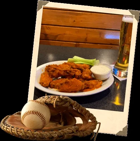 Polaroid photo of buffalo wings, beer, celery; baseball glove foreground.