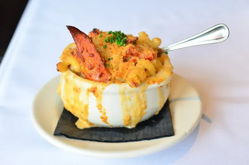 Creamy lobster mac and cheese with breadcrumbs and chives.