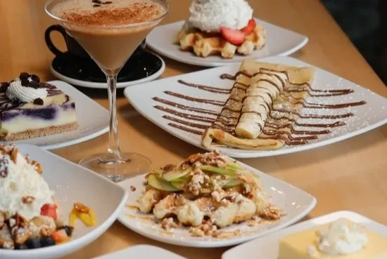 Assortment of desserts and a creamy cocktail on a table.