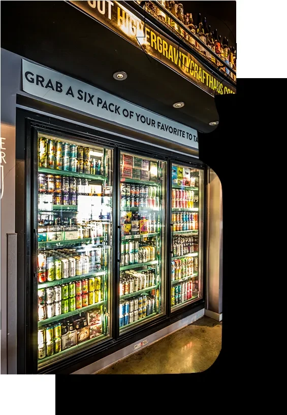Refrigerated display case filled with a wide variety of craft beverages.