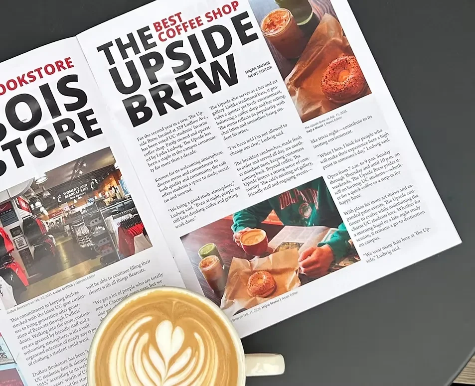A latte on an open magazine featuring a coffee shop and a bookstore.