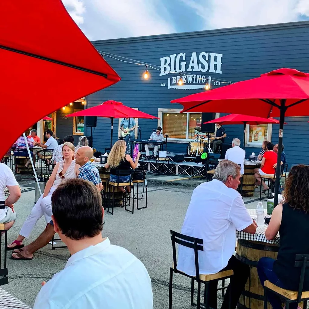 Big Ash Brewing patio: Live band entertains patrons under red umbrellas.