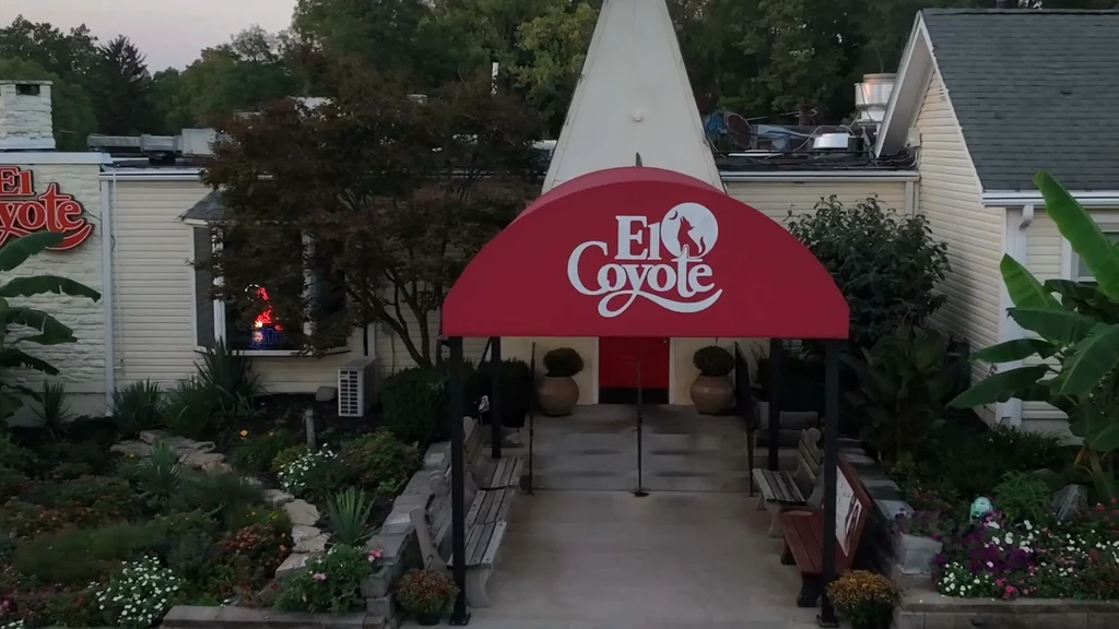 Exterior view of El Coyote restaurant with red awning and conical roof.