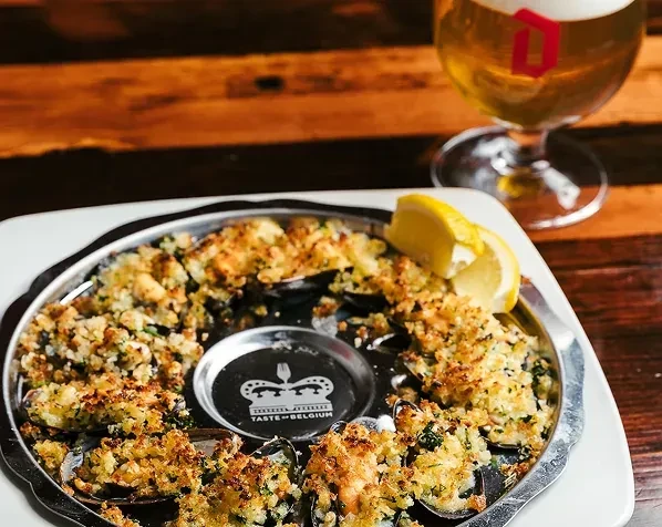 Gratinéed mussels or oysters in shells with breadcrumbs and lemon.