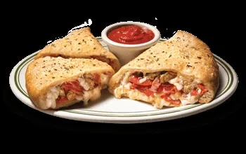 Two golden-brown pastries with pepperoni, sausage, cheese filling, and marinara.