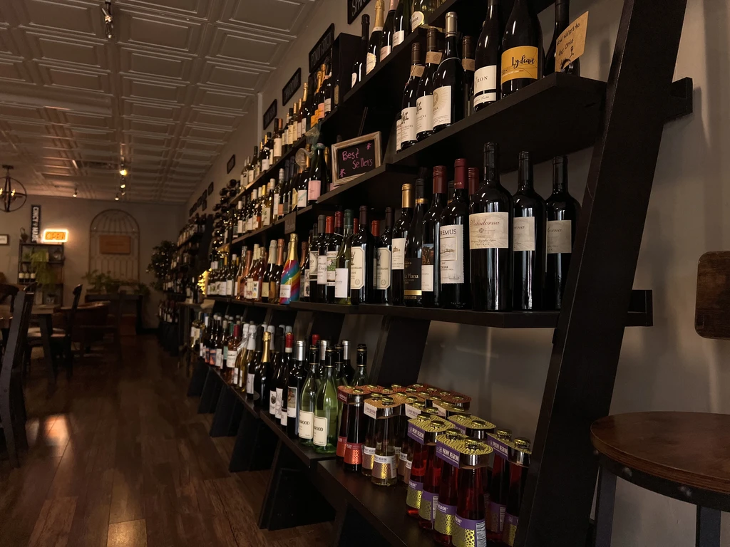Well-stocked wine shelves in a restaurant with a 'Best Seller' sign.