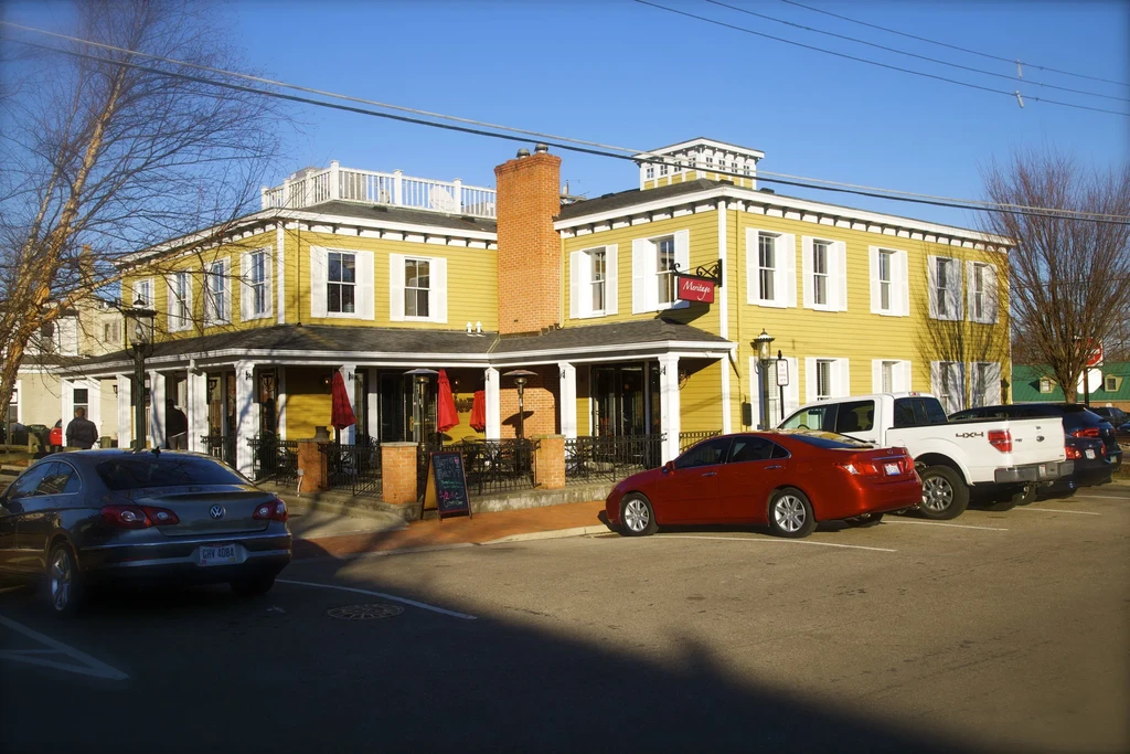 Mustard yellow 'Montage' building, outdoor dining patio, and parking.