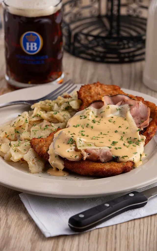 Schnitzel with ham, creamy sauce, potatoes, and Hofbräuhaus beer.
