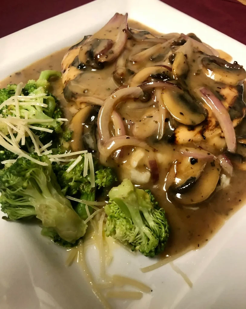 Prepared meal: Chicken with creamy sauce, mushrooms, broccoli, cheese.