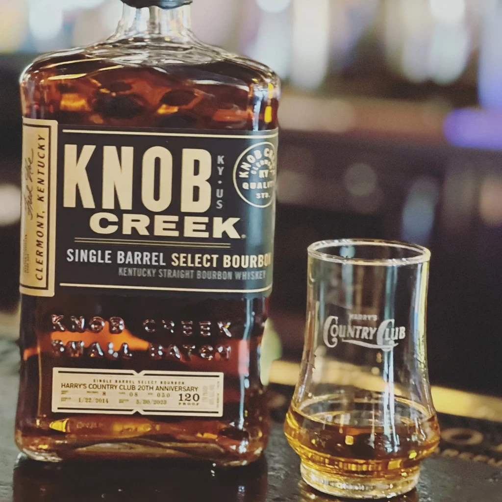 Close-up of Knob Creek bourbon bottle and Harry's Country Club glass.