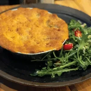 Baked pot pie in ramekin, served with a fresh green salad.