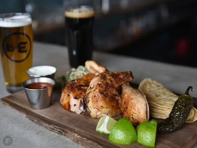 Roasted chicken, tortillas, sauces, lime, chili, and two beers.