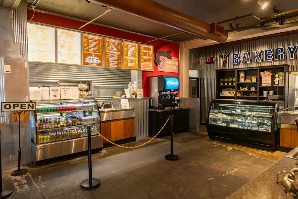 Wide shot of a modern casual restaurant with counter and bakery.