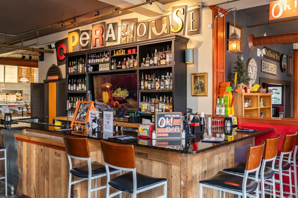 Rustic 'Opera House' bar with custom lettering and stocked shelves.