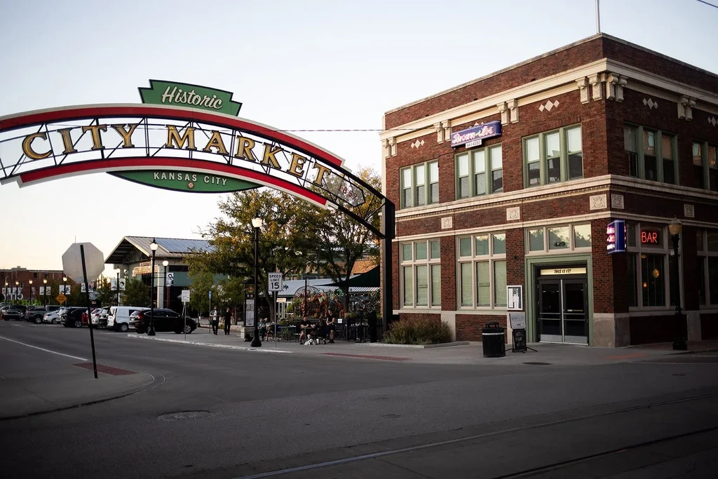 Historic City Market archway, brick building, and Strom-Jet Karaoke neon sign.