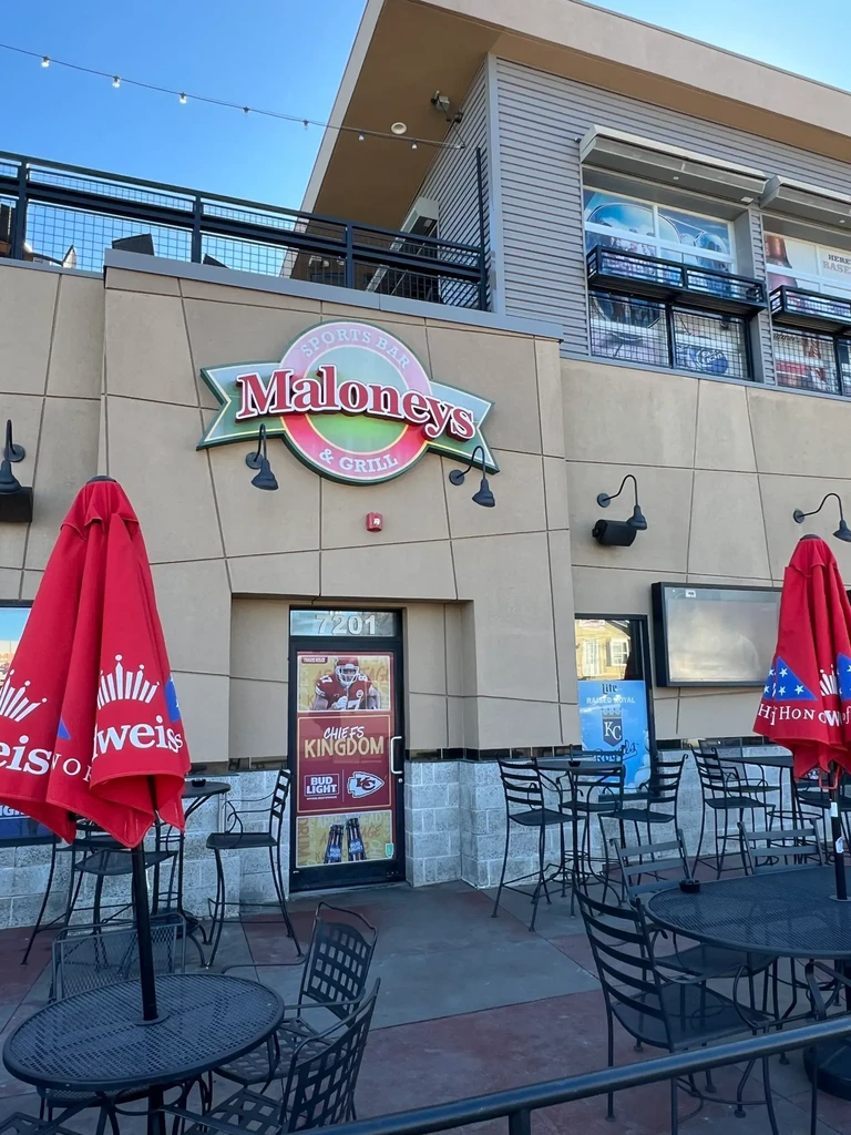 Maloneys Sports Bar & Grill exterior, patio with Budweiser umbrellas, Chiefs door.