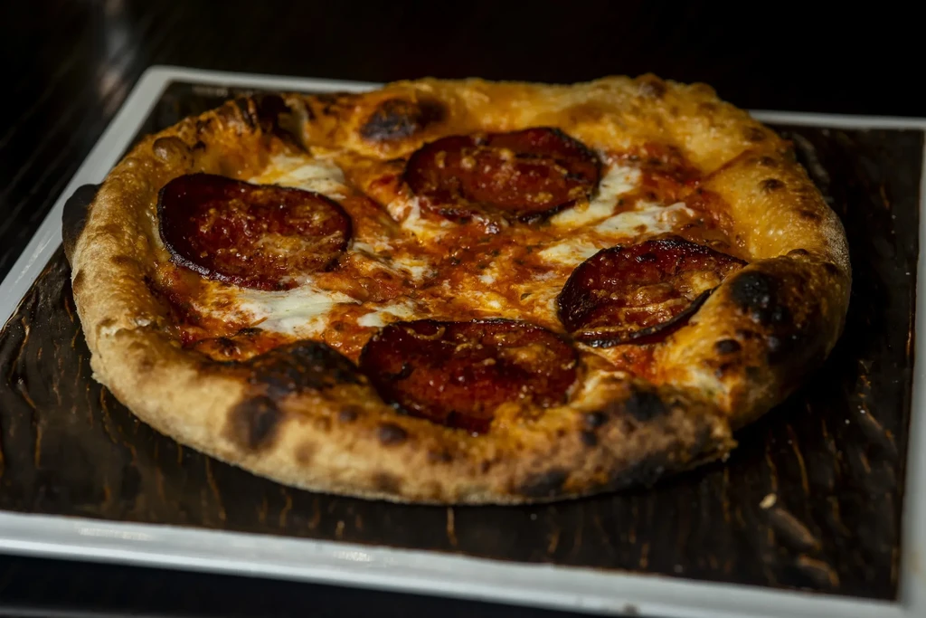 Personal Neapolitan pizza with pepperoni, melted mozzarella, and a charred crust.